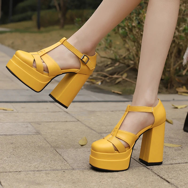 Yellow platform sandals worn outdoors on a pavement.