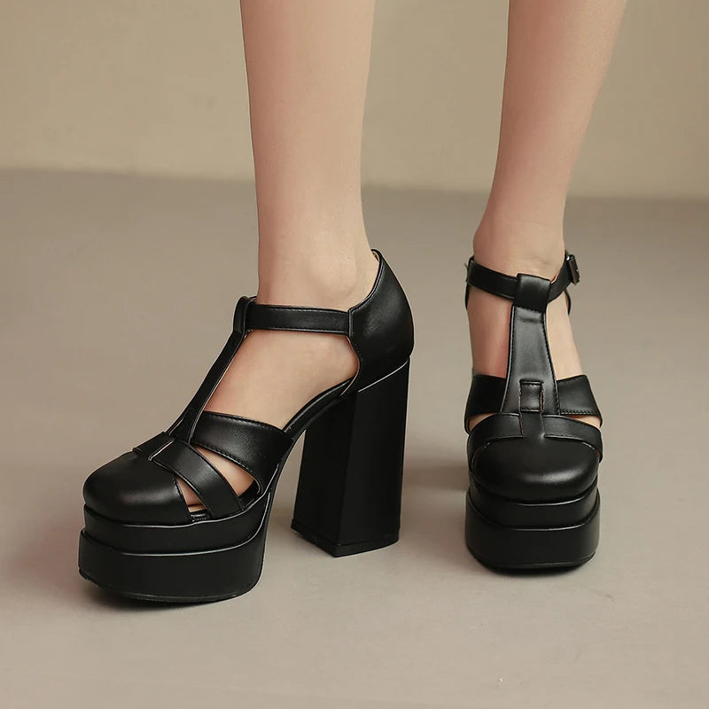 Black platform sandals on a neutral background