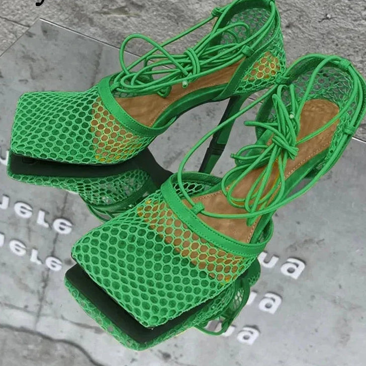 Green mesh sandals on a gray surface with 'Eilyken' branding.
